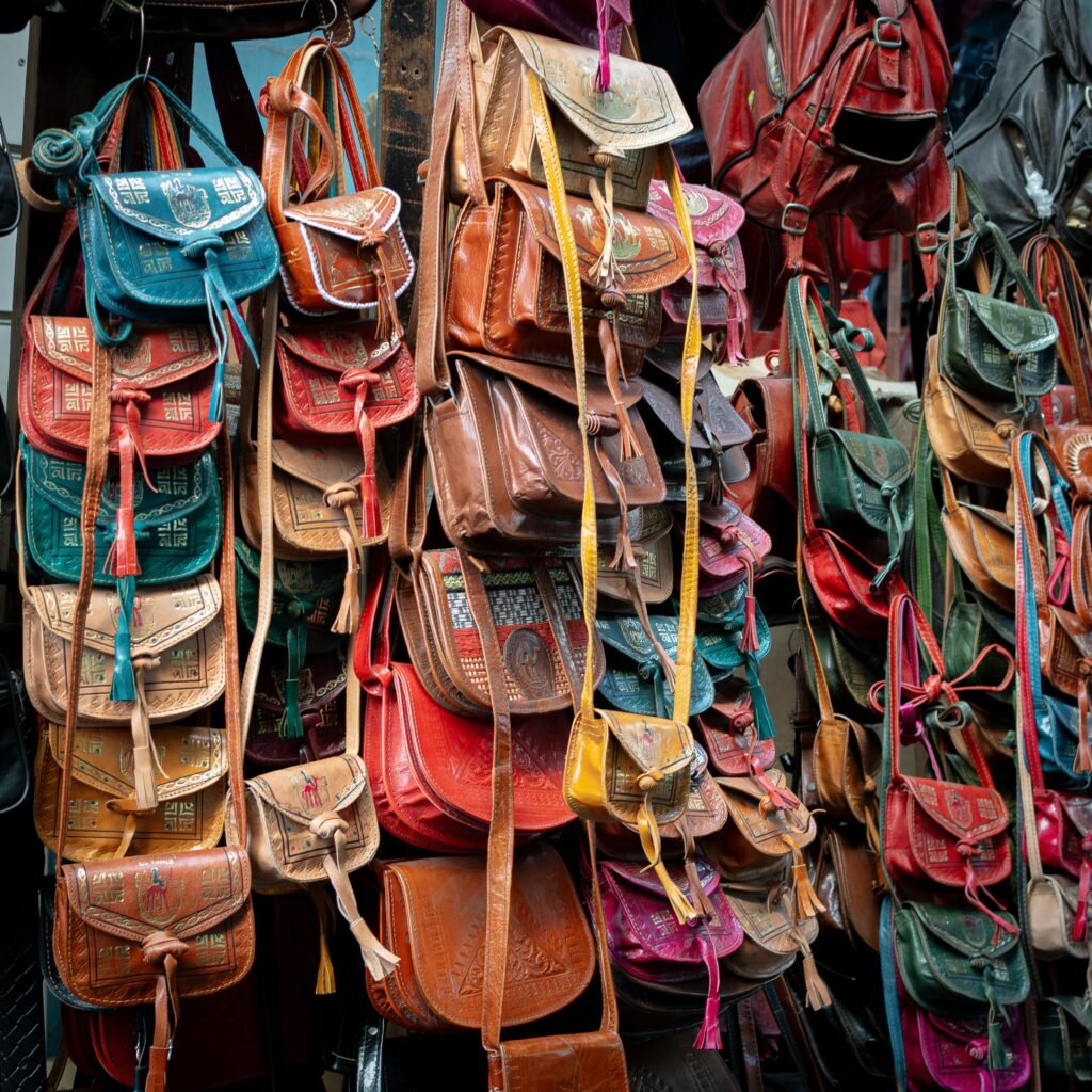 Colorful traditional leather bags on display in a Tunis souk, showcasing local craftsmanship.